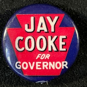 May include: A blue and red button with the text "JAY COOKE FOR GOVERNOR" in white lettering.