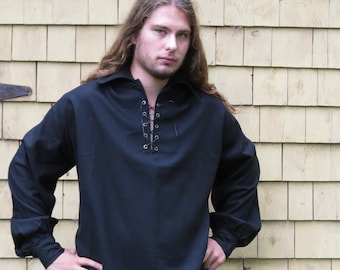 May include: A black long-sleeved shirt with a lace-up neckline. The shirt has a relaxed fit and is made of a soft, comfortable fabric.
