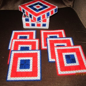 Needlepoint coasters in a needlepoint box.