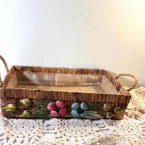 A raffia basket with flowers from the 1960s would typically reflect a charming mid-century vintage aesthetic.