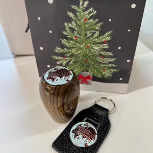 May include: A wooden gear shift knob with a globe design and a matching leather keychain with a globe design. The keychain has a silver ring.
