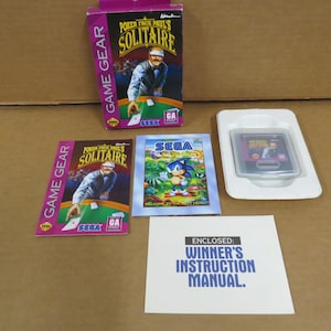 May include: A Game Gear video game set featuring "Poker Face Paul's Solitaire" and "Sonic the Hedgehog" game cartridges. The set includes the game box, game cartridges, and the instruction manual.