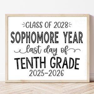 May include: A framed print with the text "CLASS OF 2028 SOPHOMORE YEAR last day of TENTH GRADE 2025-2026" in black and gray. The print is in a light wood frame and sits on a light wood surface. The bottom of the print has the text "INSTANT DOWNLOAD ~ COMES WITH GRADE SHOWN".