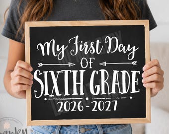 May include: A rectangular chalkboard sign with a light wood frame featuring white text that reads My First Day OF SIXTH GRADE 2026-2027. The design includes decorative arrows and horizontal lines, presenting a clear message for school milestones.