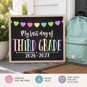 May include: A rectangular chalkboard sign with a light wood frame featuring a colorful heart garland at the top. The text reads My last day of THIRD GRADE 2026-2027 in white and multi-colored lettering against a black background.