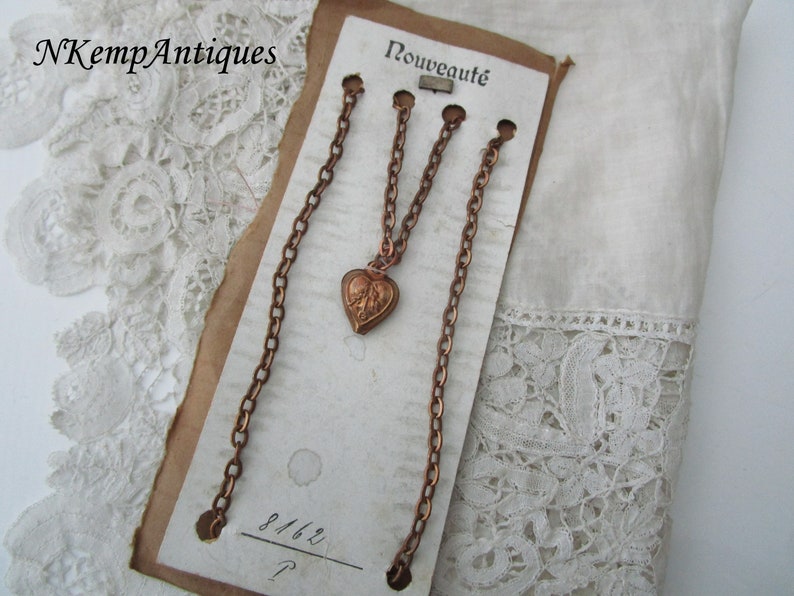 Antique heart pendant and chain on original card