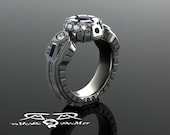 R2D2 engagement ring in hypoallergenic grey gold with diamonds and very fine blue sapphires. The most durable Star Wars wedding ring in 14k