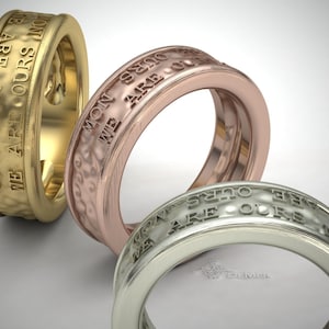 May include: Three wedding bands with the inscription "We are ours" in gold, rose gold, and silver.