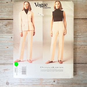 May include: Vogue Patterns sewing pattern featuring a Donna Karan design. The pattern includes a suit with a blazer and trousers, and a sleeveless top with trousers. The pattern is labelled with the number 1983.