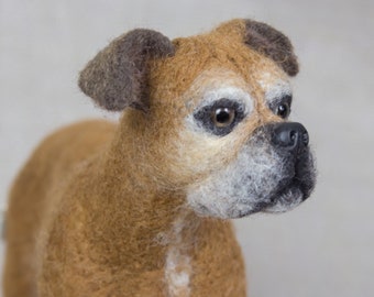 May include: A close-up of a brown and white needle felted boxer dog with black eyes and a black nose. The dog is looking to the right.