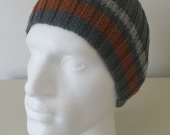 May include: Gray knitted beanie with brown and gray stripes. The beanie is on a white mannequin head.