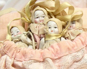 Japan Porcelain Babies in a Pouch original clothing and ribbons in woven cotton pouch Highly collectible and set is rare