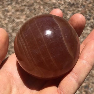 Honey Calcite Sphere comes with a stand