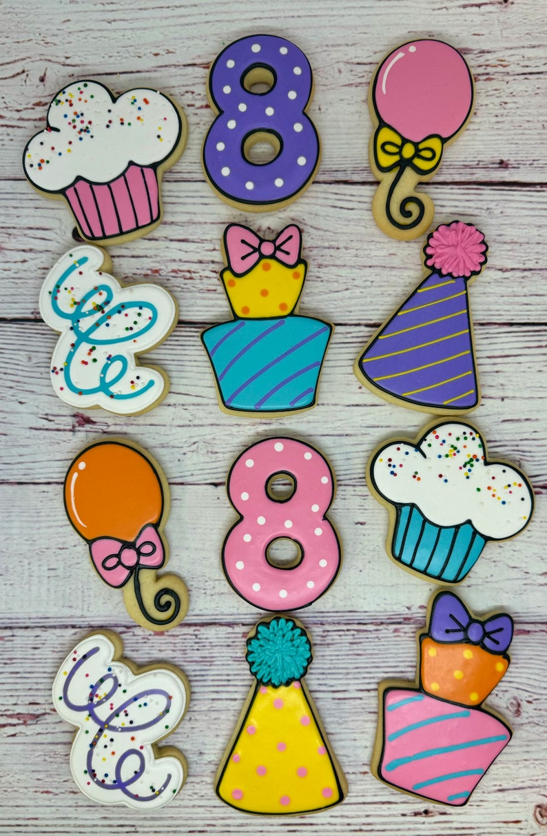 May include: A set of ten decorated sugar cookies featuring a birthday theme. The cookies are decorated with various colors, including purple, pink, yellow, blue, and orange. The cookies feature images of cupcakes, balloons, party hats, and the number eight.
