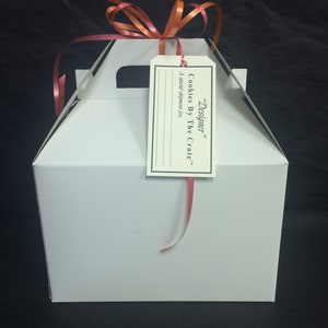 May include: White gift box with a red ribbon and a tag that says "Designer" Cookies By The Crate. A special shipment for...
