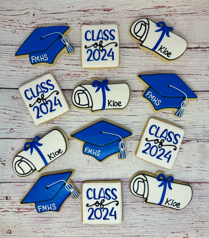 May include: Nine decorated sugar cookies with blue and white frosting. The cookies feature graduation caps, diplomas, and the text "Class of 2024". Some cookies also have the text "FMHS" and "Kloe".