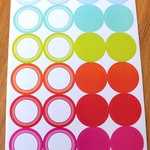 May include: A sheet of colorful round stickers with white borders and a dotted pattern. The stickers are arranged in rows of three, with each row featuring a different color: light blue, turquoise, green, orange, red, and pink.