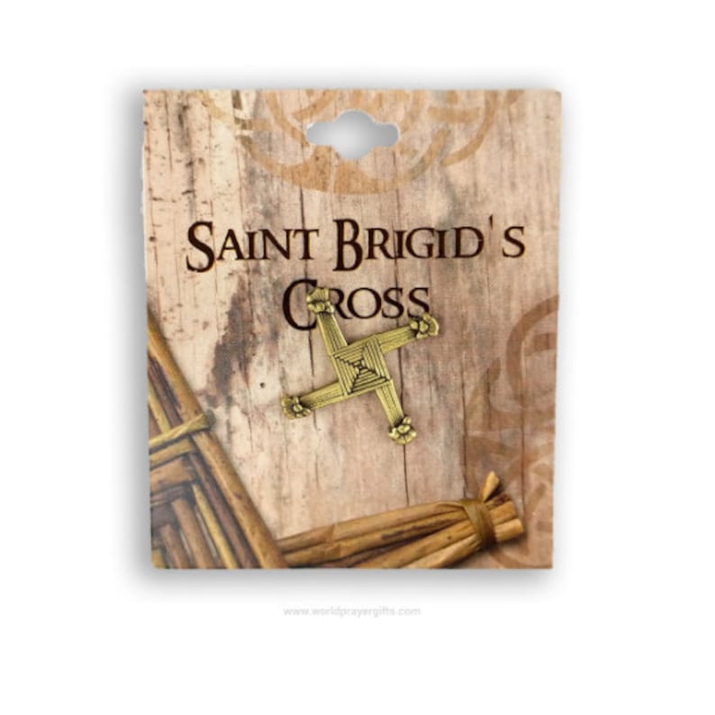 May include: A gold Saint Brigid's Cross pin on a wooden background with the text "Saint Brigid's Cross" and "www.worldprayergifts.com".
