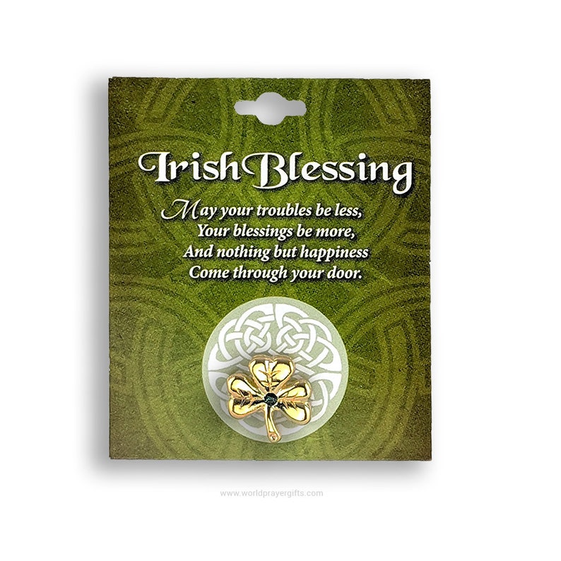 May include: Gold Irish Blessing pin with a green shamrock and a Celtic knot design. The pin is on a card with the text "Irish Blessing" and a poem about happiness.