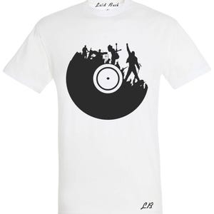 May include: White t-shirt with a black graphic of a band performing on a vinyl record. The band's silhouettes include a singer, guitarist, drummer, and bassist. The text "Laid Back" is printed on the top of the shirt, and "LB" is printed on the bottom.