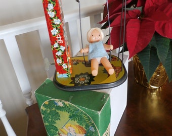 Vintage 1970s Kayejin Wind Up Tin Toy Girl on Swing with Box & key.  Made in the USSR at the Moscow toy factory "Orlonok" in 1975.