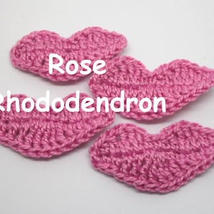 May include: Four pink crocheted heart shapes, two labeled "Rose" and two labeled "Rhododendron".