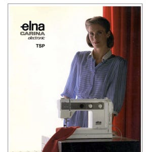 May include: An Elna Carina electronic TSP sewing machine is shown. The machine is white with black detailing and has three control knobs. Red fabric is draped beneath the needle. The Elna logo is visible on the machine.