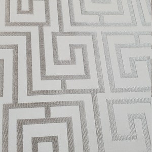 May include: White wallpaper with a silver geometric pattern of interlocking squares and rectangles.
