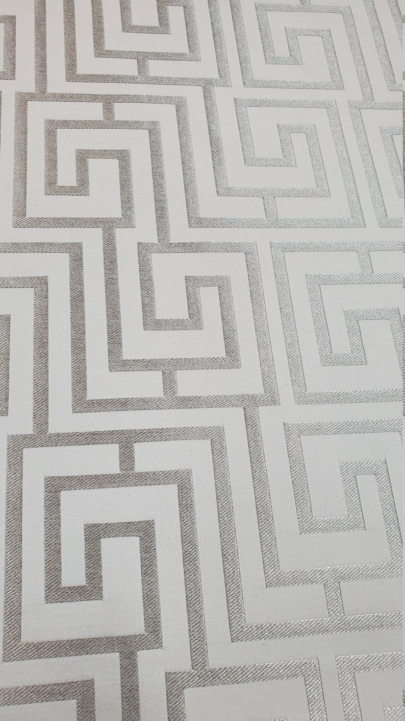 May include: White wallpaper with a silver geometric pattern of interlocking squares and rectangles.