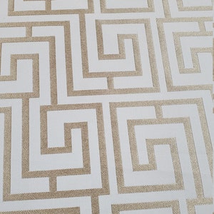 May include: White wallpaper with a gold geometric pattern of interlocking squares and rectangles.