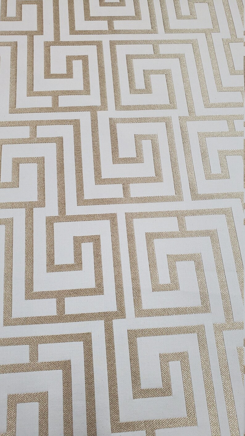 May include: White wallpaper with a gold geometric pattern of interlocking squares and rectangles.
