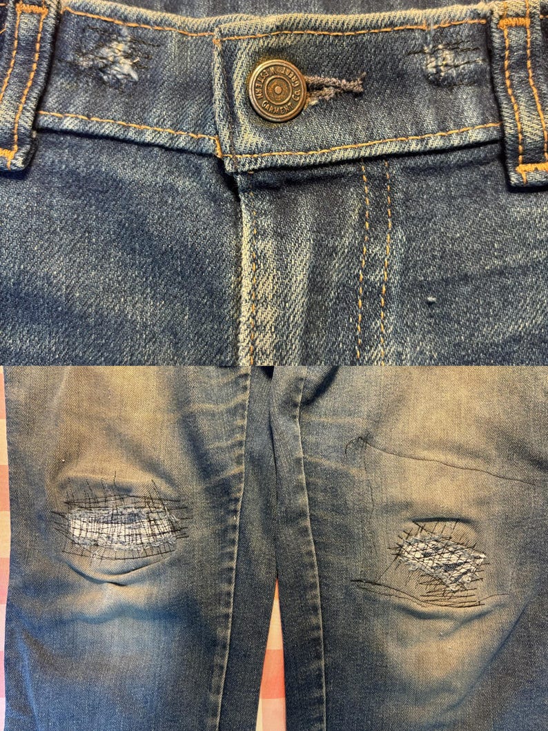 May include: Close-up of blue denim jeans with a button closure and distressed details. The jeans have visible wear and tear, including patches on the knees. The button is a metallic color with the text "Garment Co."