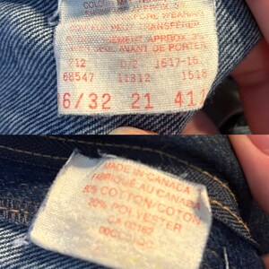 May include: Close-up of denim fabric with two tags. One tag has text including "COLOUR MAY TRANSFER" and size information "6/32 21 41". The other tag reads "MADE IN CANADA" and fabric content.