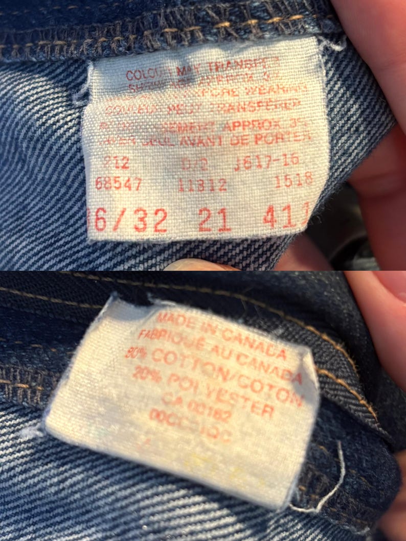 May include: Close-up of denim fabric with two tags. One tag has text including "COLOUR MAY TRANSFER" and size information "6/32 21 41". The other tag reads "MADE IN CANADA" and fabric content.