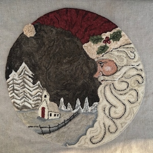 May include: A round, hand-stitched wool rug depicting Santa Claus's face and beard, with a snowy winter scene in the background. The scene includes a small house and trees.