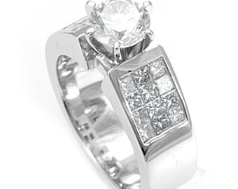 May include: A silver engagement ring with a large round center diamond and a square band with smaller diamonds set in a pave setting.