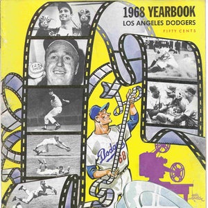 May include: A 1968 Los Angeles Dodgers yearbook cover with a film reel design. The cover features a cartoon baseball player holding a film reel and a projector. The text "1968 Yearbook Los Angeles Dodgers Fifty Cents" is printed on the cover. The text "10 Years of Thrills with the Dodgers" is printed on a white label.