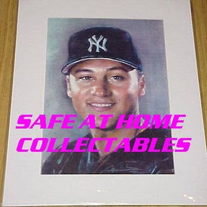 May include: A color illustration of a baseball player wearing a black and white New York Yankees baseball cap. The player is looking directly at the viewer. The image is framed and has the text "SAFE AT HOME COLLECTABLES" printed on the bottom.