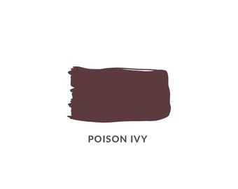 May include: A rectangular swatch of dark burgundy paint with rough edges, labelled "POISON IVY" in a sans-serif font. The paint colour is a deep, muted shade of red-brown, resembling dried leaves.