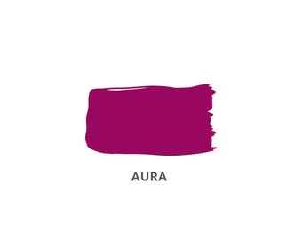 May include: A rectangular brushstroke of deep magenta paint against a white background. The word "AURA" is printed in a simple sans-serif font below the paint swatch. The paint has a textured appearance.