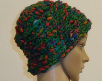 Knitted green cap with colorful studs