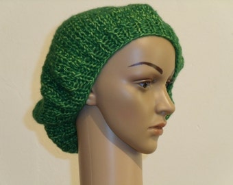 Knitted beret made of light green fluffy yarn