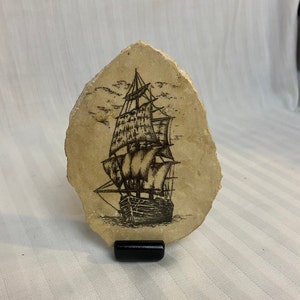 Ship drawing on stone with stand