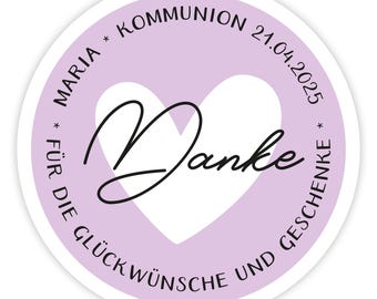 May include: A purple circle with a white heart in the centre. The heart has the word "Danke" written in black cursive inside. The circle has the text "MARIA * COMMUNION 21.04.2025 * FÜR DIE GLÜCKWÜNSCHE UND GESCHENKE *" written around the edge.