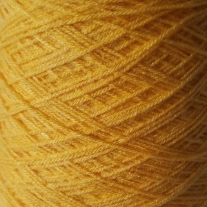 May include: A cone of bright yellow yarn.