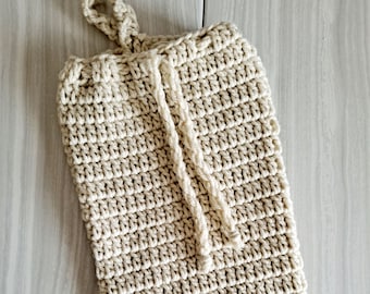 May include: A beige crocheted bag with a drawstring closure and a loop handle.