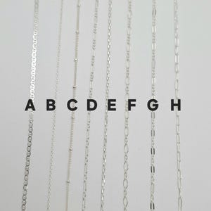 May include: Eight distinct silver-toned metal chains arranged vertically and labeled A through H. The chains feature various link styles including mariner, cable, satellite, figaro, rope, oval, bar, and elongated paperclip link designs.