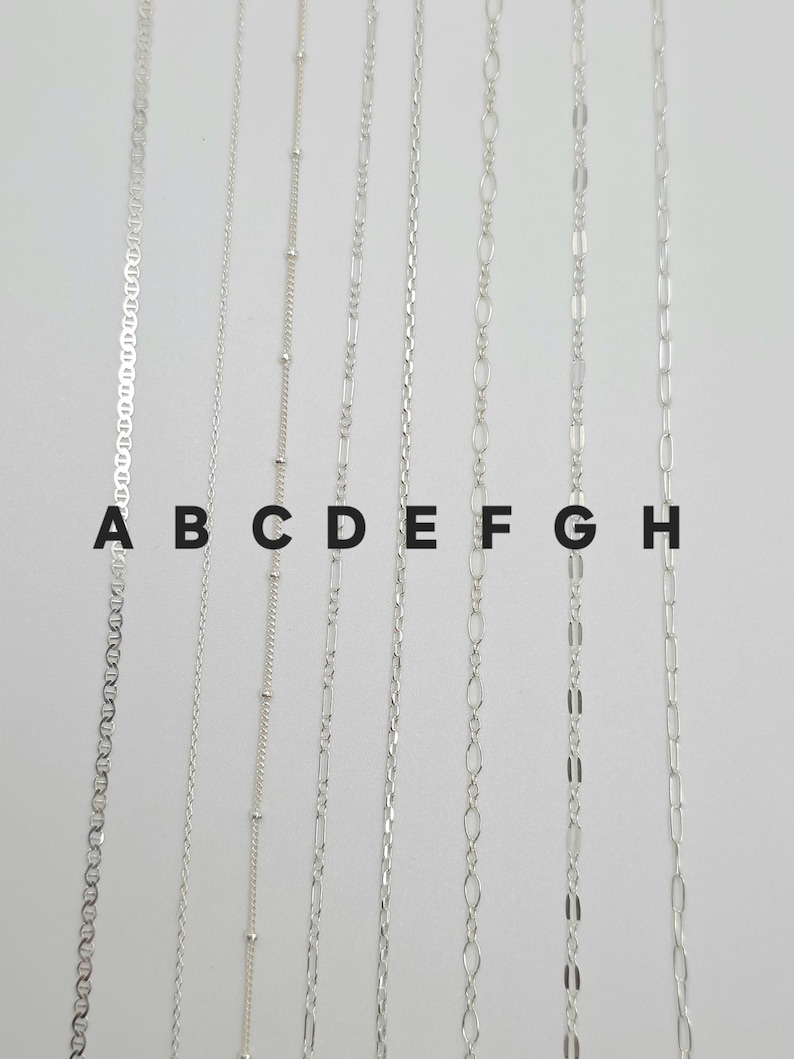 May include: Eight distinct silver-toned metal chains arranged vertically and labeled A through H. The chains feature various link styles including mariner, cable, satellite, figaro, rope, oval, bar, and elongated paperclip link designs.