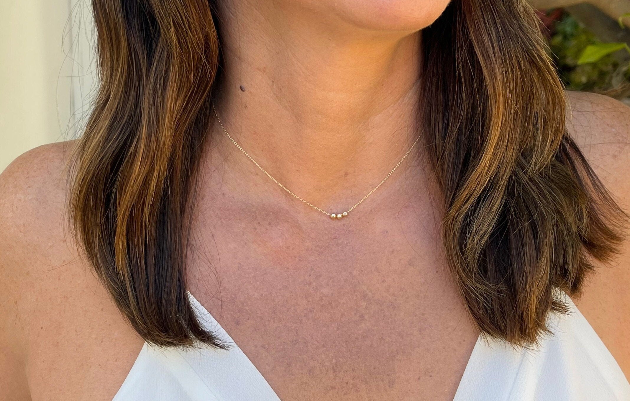 Tiny gold store bead necklace