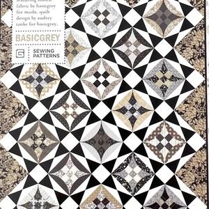 May include: A black and white quilt with a geometric pattern. The quilt is made up of squares and triangles, and the fabric is a mix of black, white, and gray. The quilt is called "Whylo Star Quilt" and the pattern is called "Patoo2".